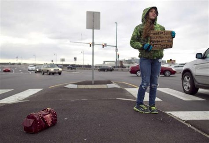 Is it illegal to give a panhandler money?
